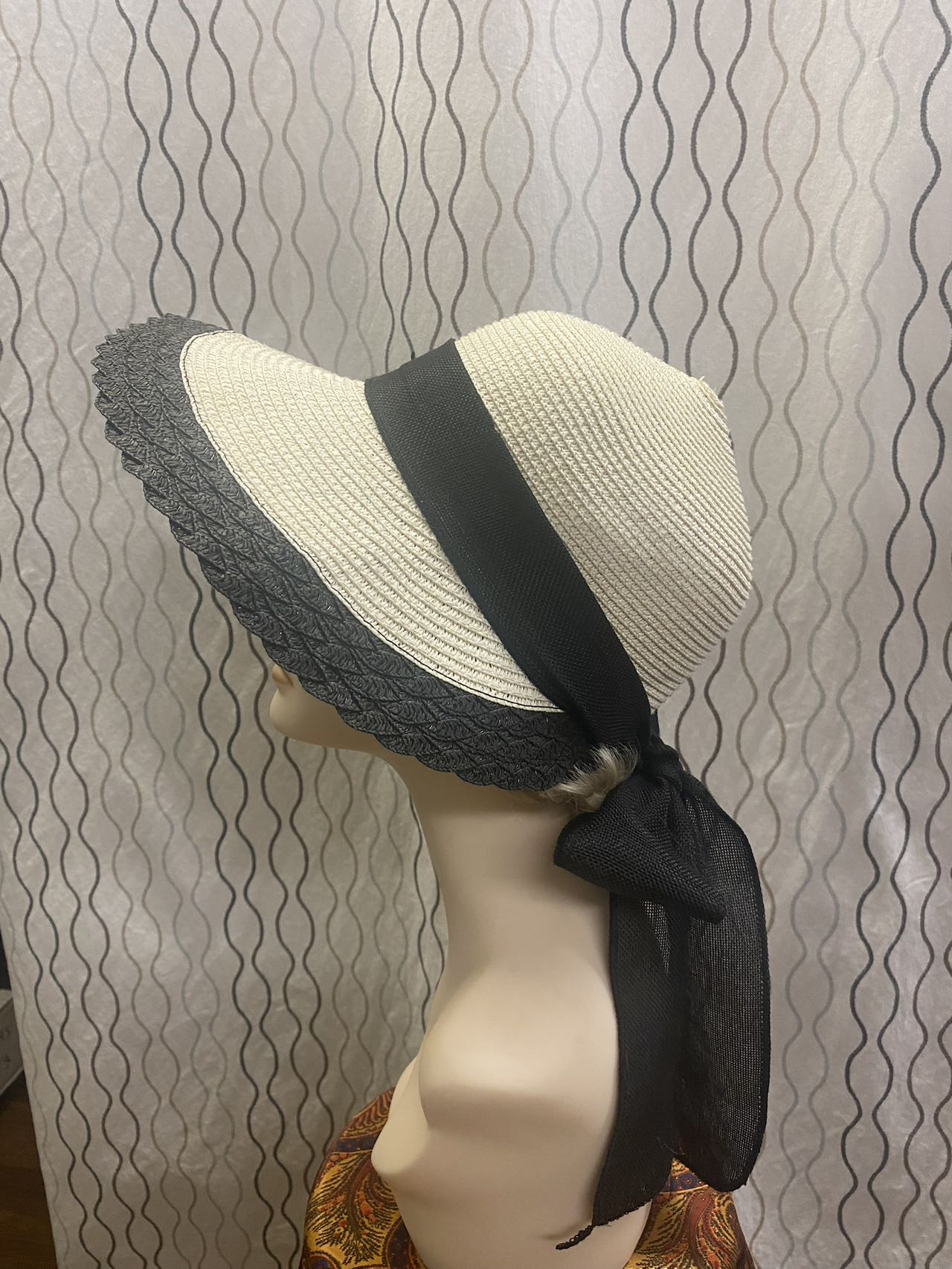 women beige straw sunbonnet with black ribbon